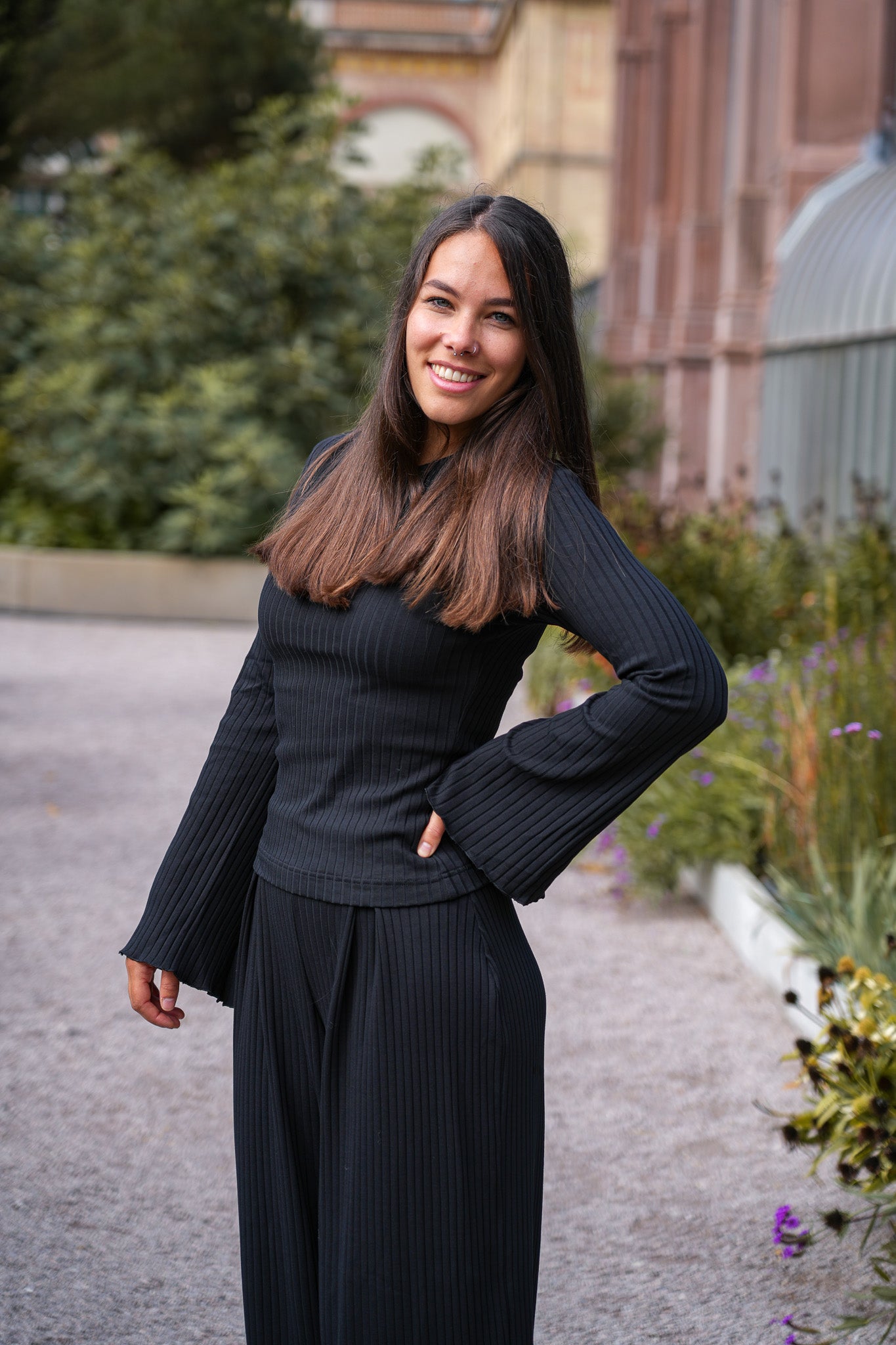 Enganliegender Pullover aus Bio-Baumwolle in Schwarz, mit Trompetenärmeln und Rüschensaum.